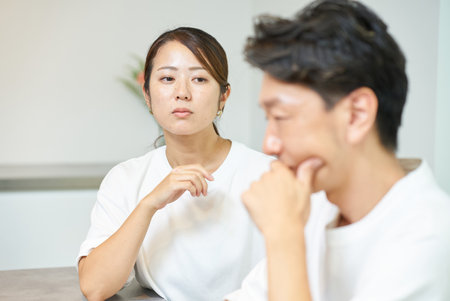 A wife who suspects her husband and a middle-aged husband who is the one being suspectedの写真素材