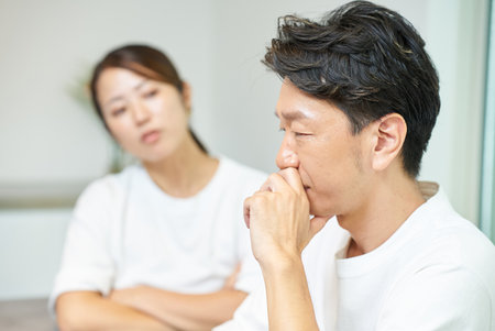 A wife who suspects her husband and a middle-aged husband who is the one being suspectedの写真素材