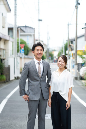 Portrait of a businessman and businesswoman standing on the streetの写真素材