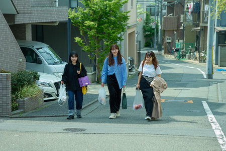 Three women walking in the city on fine dayの写真素材