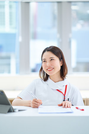 Portrait of a young woman in a white coatの写真素材