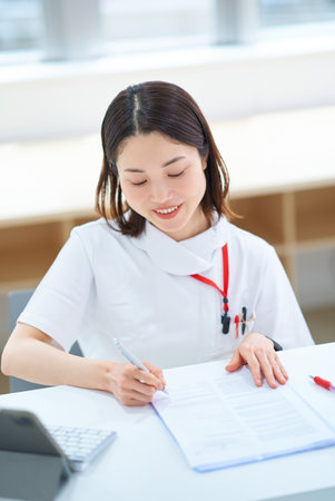 Portrait of a young woman in a white coatの写真素材