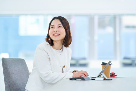 A young woman working in a friendly atmosphereの写真素材
