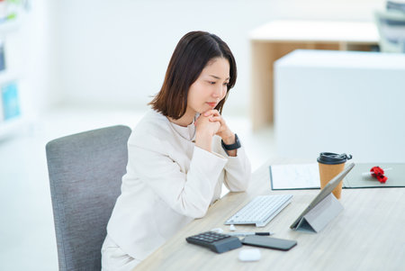 A young woman suffering from stiff shouldersの写真素材
