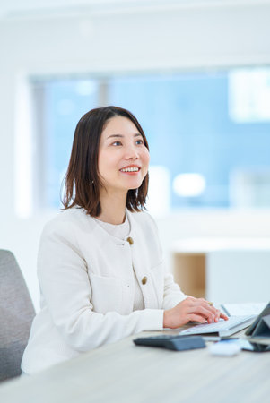 A young woman working in a friendly atmosphereの写真素材