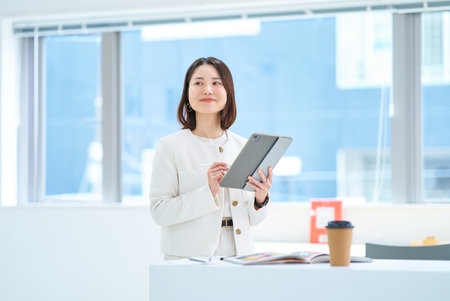 A young woman operating a tablet PCの写真素材