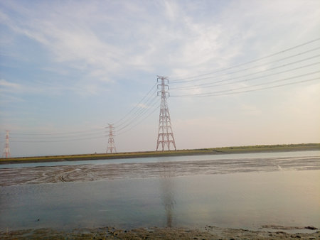 High voltage power line and pylons in the countryside, Thailand.