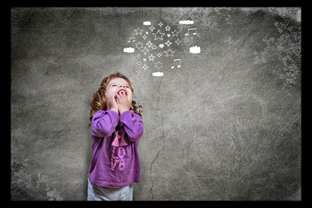 Joyful beautiful girl in night suit thinking at stars and heartsの写真素材