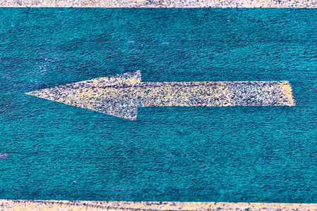 Yellow directional arrow on a bicycle laneの写真素材