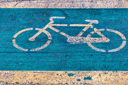 Bicycle lane with yellow byke signe on green backgroundの写真素材