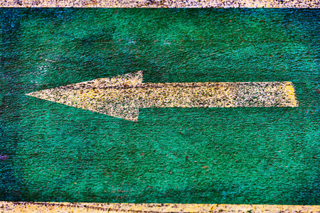 Vintage yellow directional arrow on a bicycle laneの写真素材