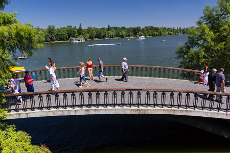 BUCHAREST, ROMANIA - AUGUST 15, 2012. The Herastrau park visited by a lot of people in summer. They can have boat trips on the lakeのeditorial素材