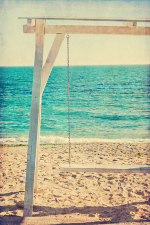 Retro white wooden swing at the shore of Black Sea in Romaniaの写真素材