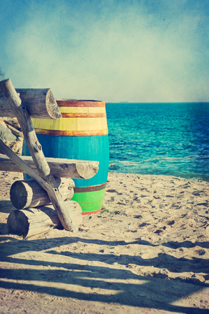 Old wooden colored barrel at the sea shore, vintage styleの写真素材