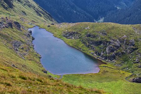 Small glacial lake Buda in Fagaras mountains close to Transfagarasan roadの写真素材