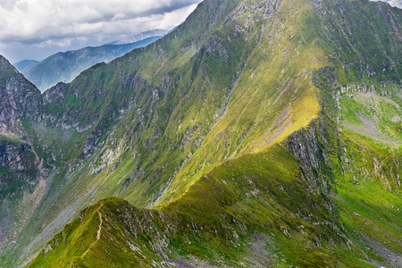 Fagaras mountains in Romanian Carpathians, with a people on the trail at Nerlinger monumentの写真素材