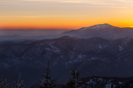 Buila-Vanturarita mountain seen from Cozia mountain at dusk during winterの写真素材