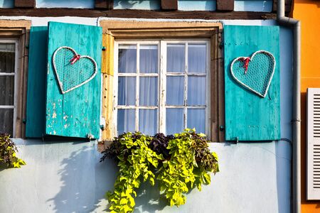 Open old wooden shutter on a window in Colmar Franceの写真素材