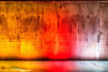 Water falling on a concrete wall on dancing colorsの写真素材