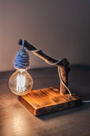 Unique handmade table lamp from driftwood and vintage bulb lightの写真素材