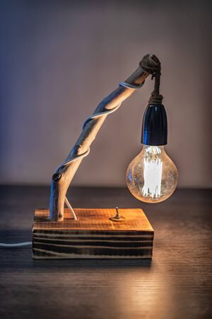 Unique handmade table lamp from driftwood and vintage bulb lightの写真素材
