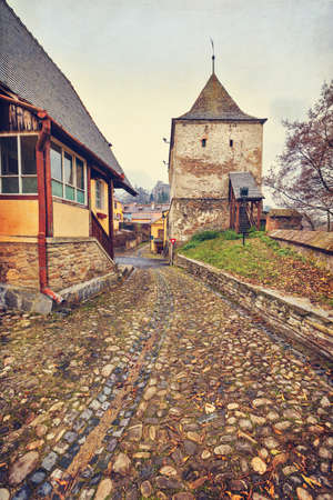Taylor Tower gate of Sighisoara citadel in Transylvania, Romania, in vintage filterの写真素材