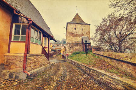 Taylor Tower gate of Sighisoara citadel in Transylvania, Romania, in vintage filterの写真素材