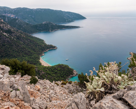 View from the tracking route of the Lycian Trail. Taurus Mountains and blue sea waters. Cennet Koyu Paradise Bay in Bodrum District of Turkeyの写真素材