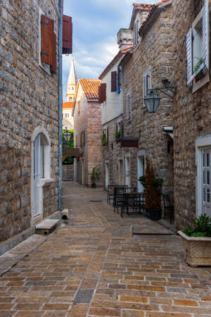Ancient stone street in Budva, Montenegro. Narrow streets and a view of the ancient citadel. Fort on the Adriatic Sea.の写真素材
