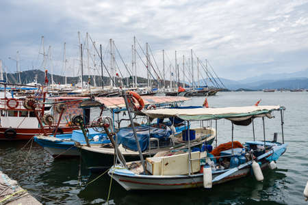 Yachts and boats in the harbor, Fethie, Turkey. The promenade of the city of Fethiye, boats are at bay in the blue waters of the Mediterranean. The resort town of Turkey.の写真素材