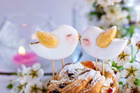 On grey wooden table cake, Easter cake in a basket or in a wooden, grey box, spring flowers, sweet table for the holiday, Easter Holiday, Easter decor.の写真素材