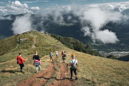Young hikers trekking in Svaneti, Georgia. Shkhara mountain in the background. Amazingly beautiful...