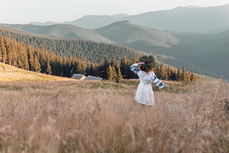 Young Ukrainian woman in traditional national embroidered skirt at sunset. Ethnic ukrainian national...