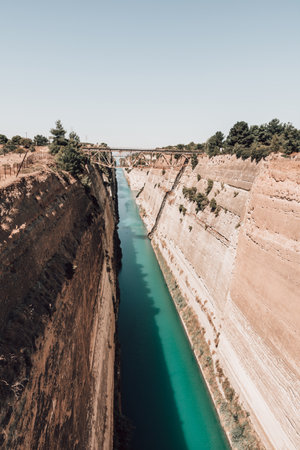 The Corinth Canal is a canal that connects the Gulf of Corinth with the Saronic Gulf in the Aegean Sea. It cuts Isthmus of Corinth and separates Peloponnese from the Greek mainland.の写真素材