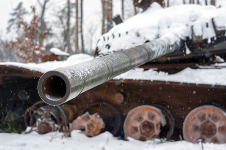 Russian battle tank in the snow which was destroyed on the roadside of highway during hostilities in...