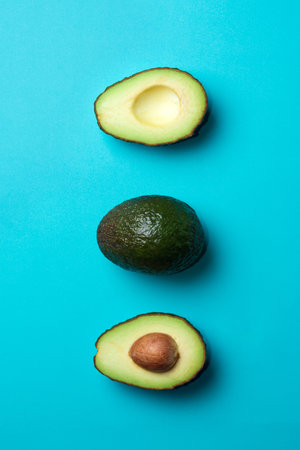 Fresh avocados on a blue background. Banner with free space for text. Healthy Eating.