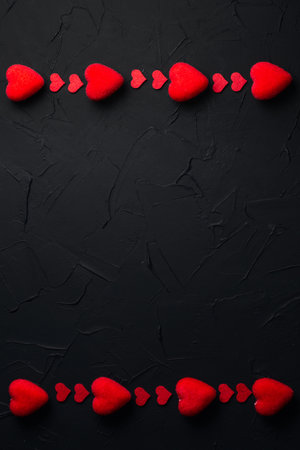 Vertical baner for Valentine's day. Black background with red hearts. Place for text.の写真素材