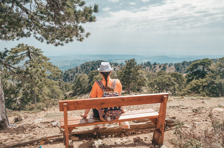 Girl sitting on the bench in Troodos mountain, Cyprusの写真素材