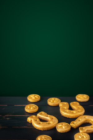 Vertical Saint Patricks day background with gold horseshoe and four leaf clovers on a dark backgroundの写真素材