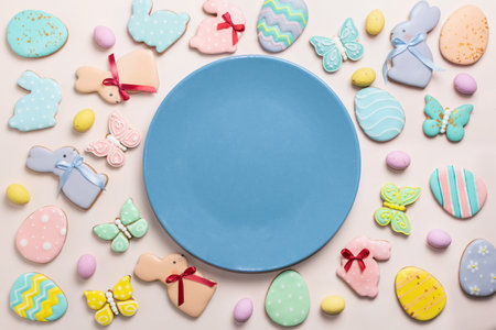 Easter banner on a pastel background. Homemade gingerbread cookies on a blue plate, Easter eggs and...