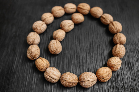 Lots of fresh nuts on a black wooden background. Best practices for designer. Isolated place for...
