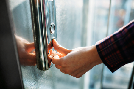 The thumb presses the Elevator button, a hand reaching for the button, the girl waiting for Elevator, push button start, isolated