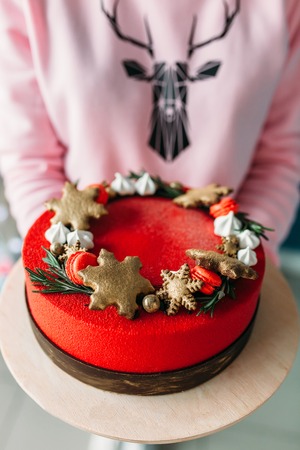 Girl hands holding a beautiful Christmas cake, Christmas cake, customの写真素材