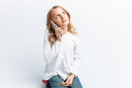 Beautiful teen girl talking on mobile phone, photo Studioの写真素材