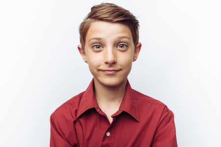 Portrait of smiling cute teen on white background, in red shirt, advertisement,の写真素材