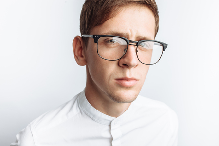 Portrait of young attractive guy in glasses, in white shirt, isolated on white background,の写真素材