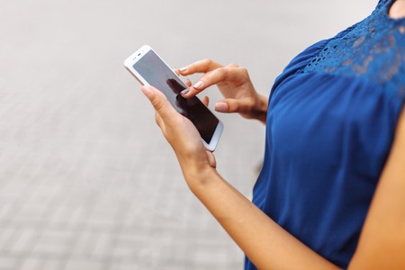 Woman with phone and shopping in hand, shopping onlineの写真素材