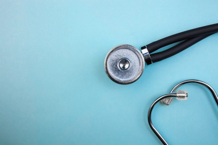 Medical pressure gauge and stethoscope on light blue background, for heart listening, isolated placeの写真素材