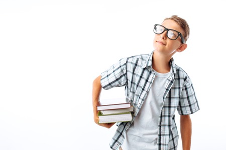 Beautiful student holding a stack of books, a botanist goes with books to study in the Studioの写真素材