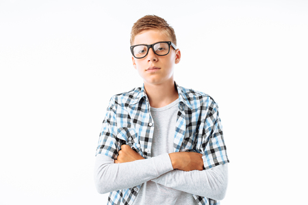 Portrait of beautiful boy with glasses, teen nerd smiling, in Studioの写真素材